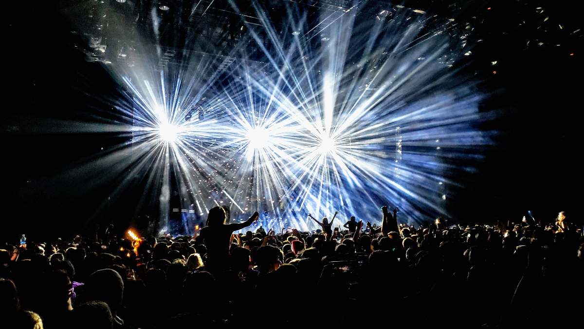 person time lapse photography of group of people facing on stage lighting