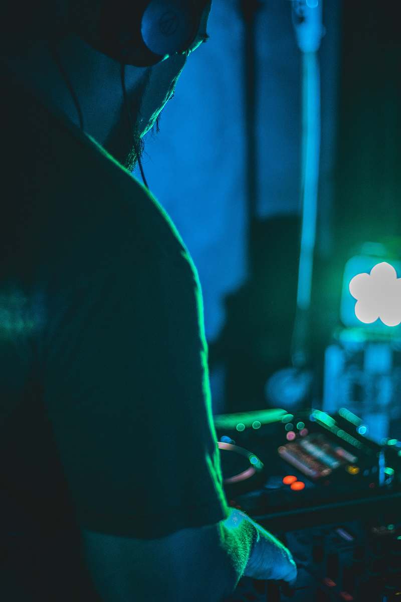 human woman in black shirt playing dj controller person
