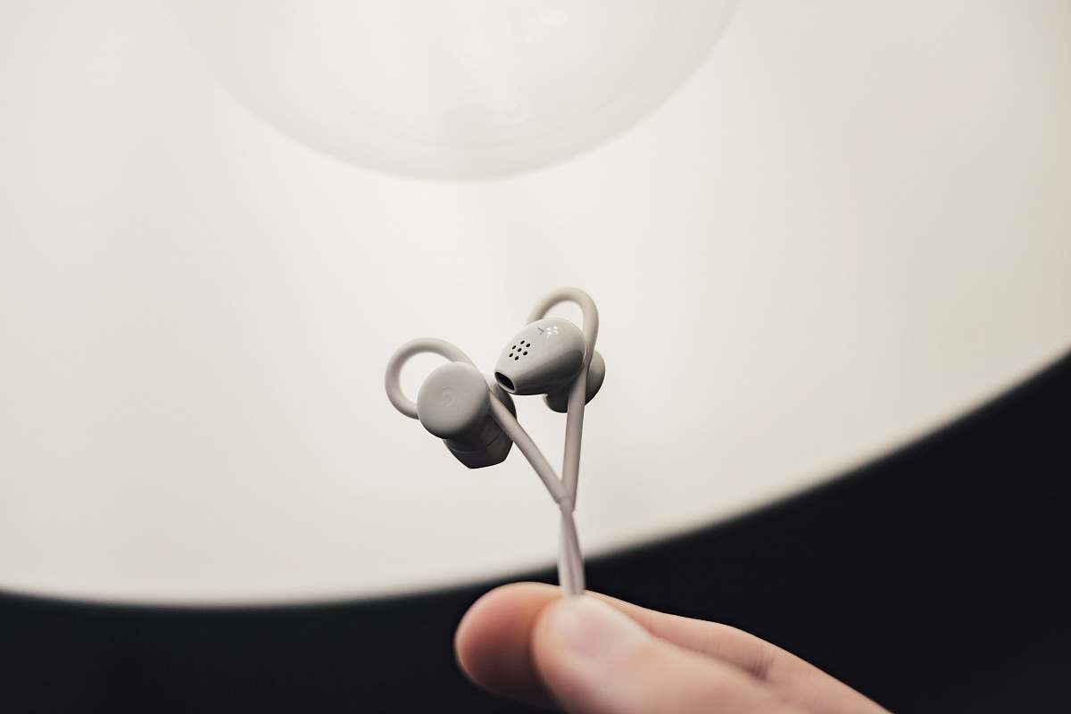 headphones person holding gray earphones headset