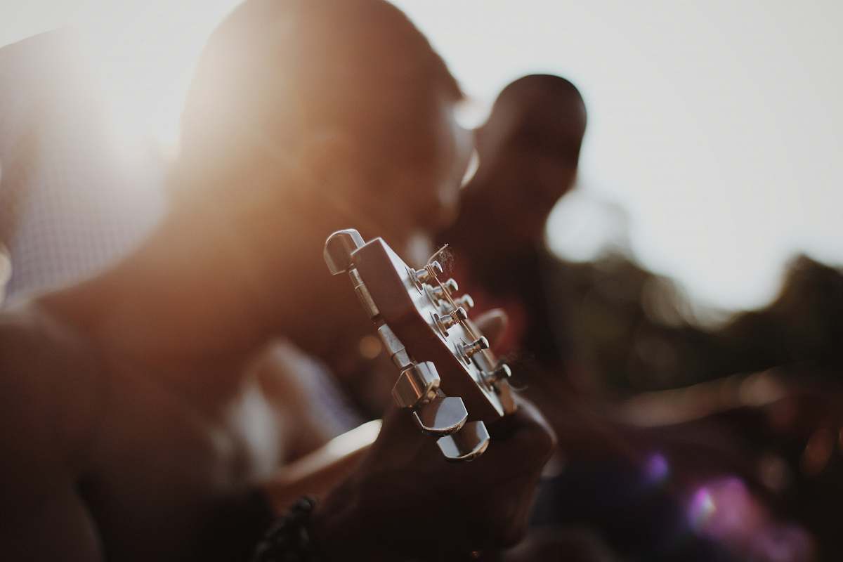 france man playing guitar brown