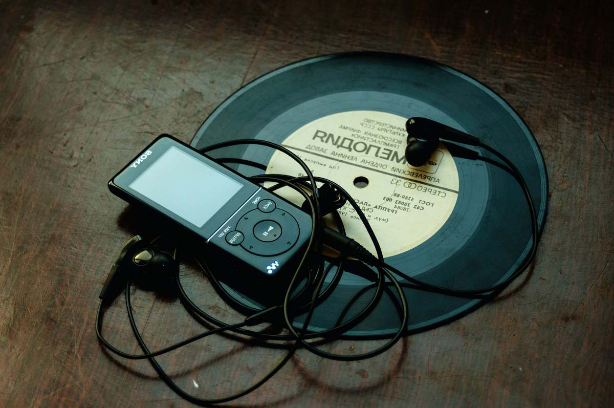 belarus in-ear headphones plugged in black Sony Walkman on vinyl record music
