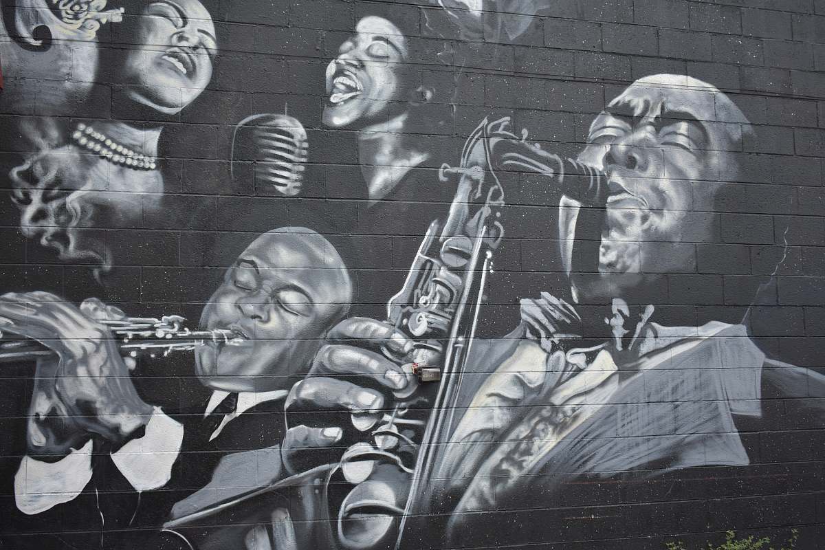 detroit grayscale photo of men playing musical instruments mural