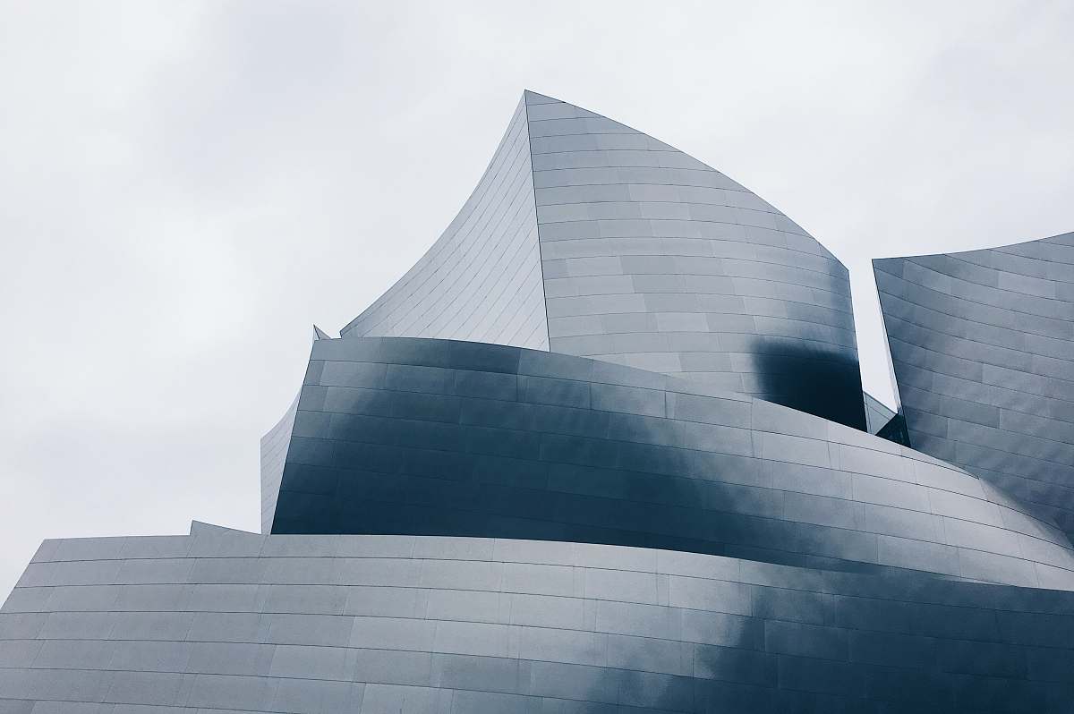 crowd photo of building top under gray sky audience