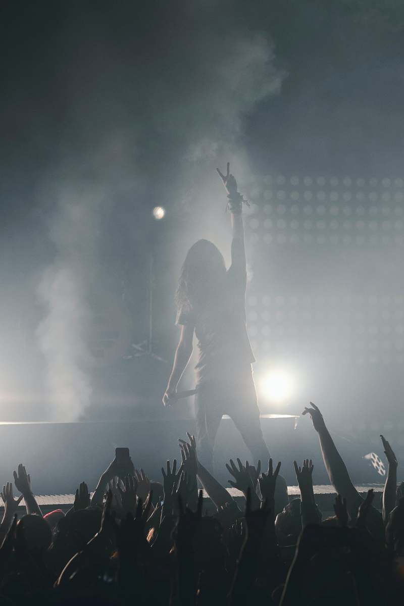 anaheim woman standing on stage holding microphone concert