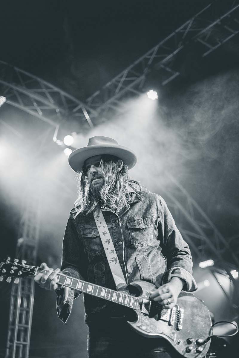 grey man playing guitar guitarist