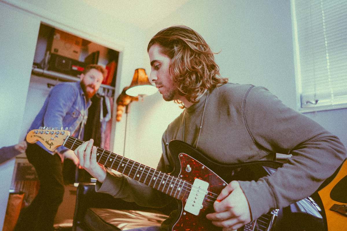 musician man playing guitar while the other sings guitarist
