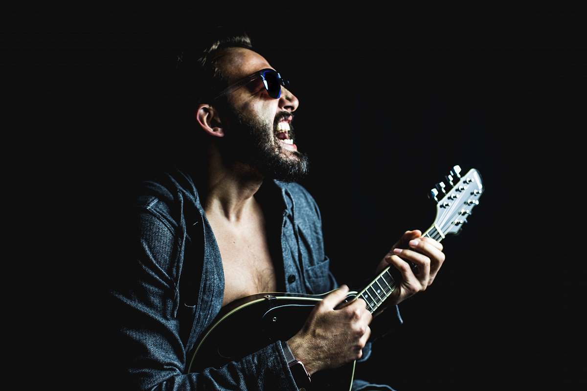 musician man playing string instrument person