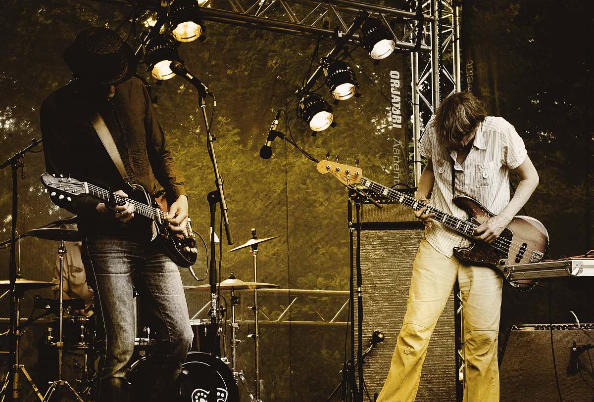human two men performing guitar on stage people