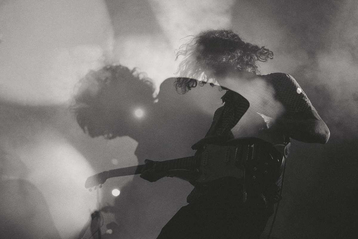 people A black-and-white shot of a man playing electric guitar in double exposure person