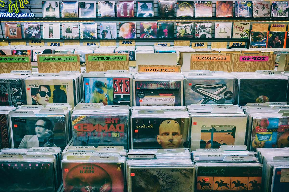 person assorted-artist record sleeve inside record shop shelf