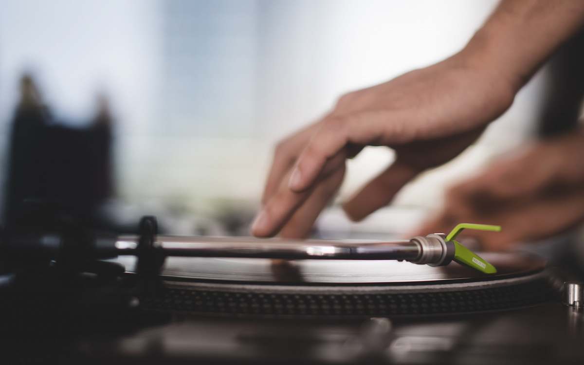 person close-up photo of person using turntable hand