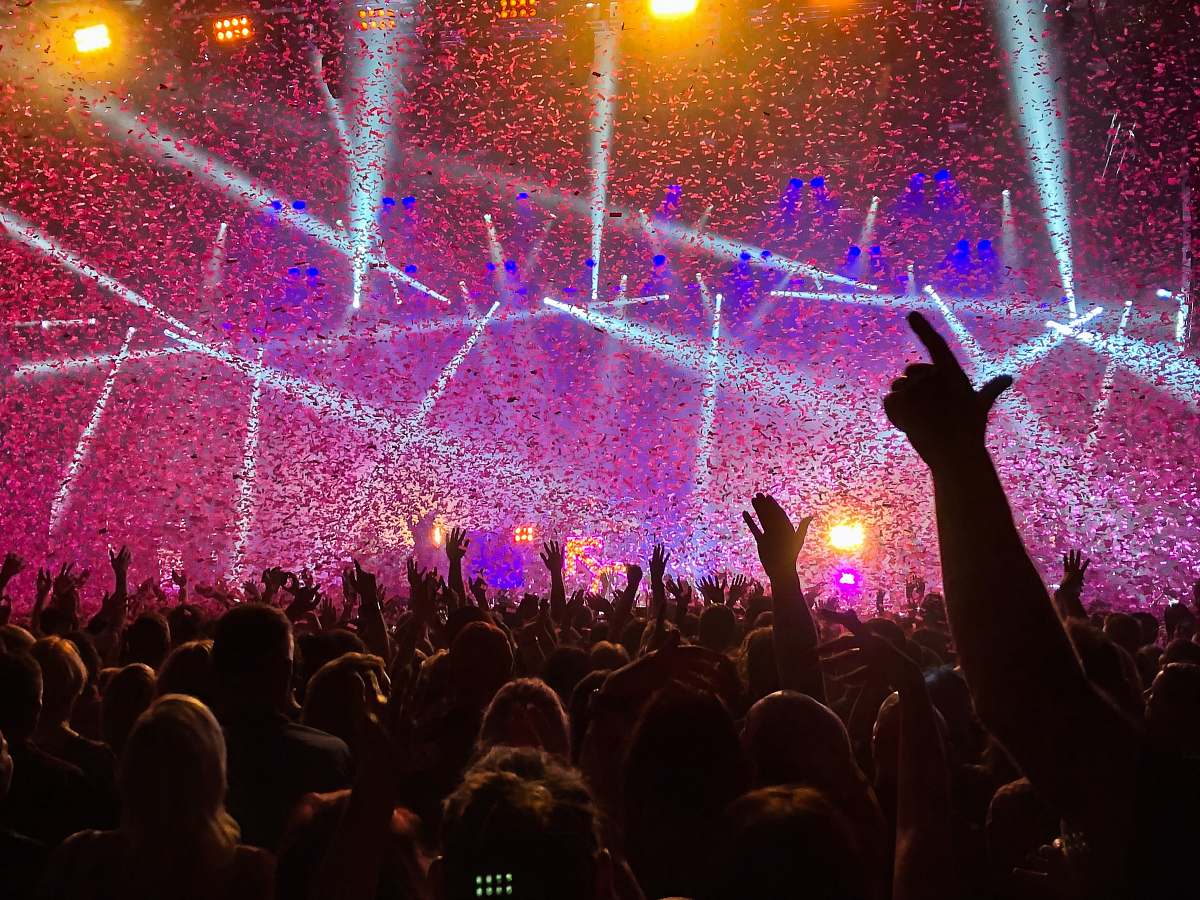 person crowd raising their hands lighting
