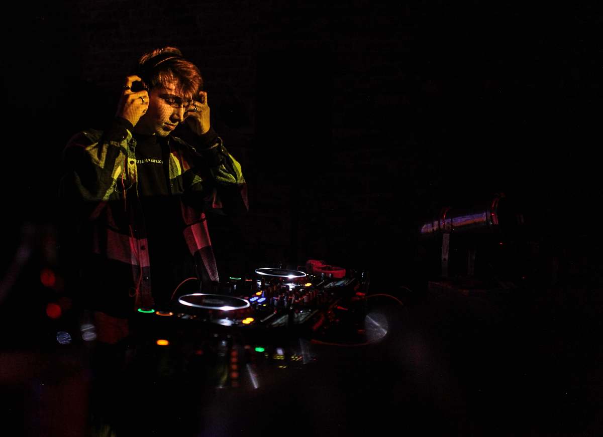 person DJ playing controller people