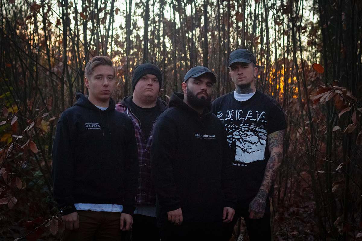 apparel four men standing on front of woods clothing