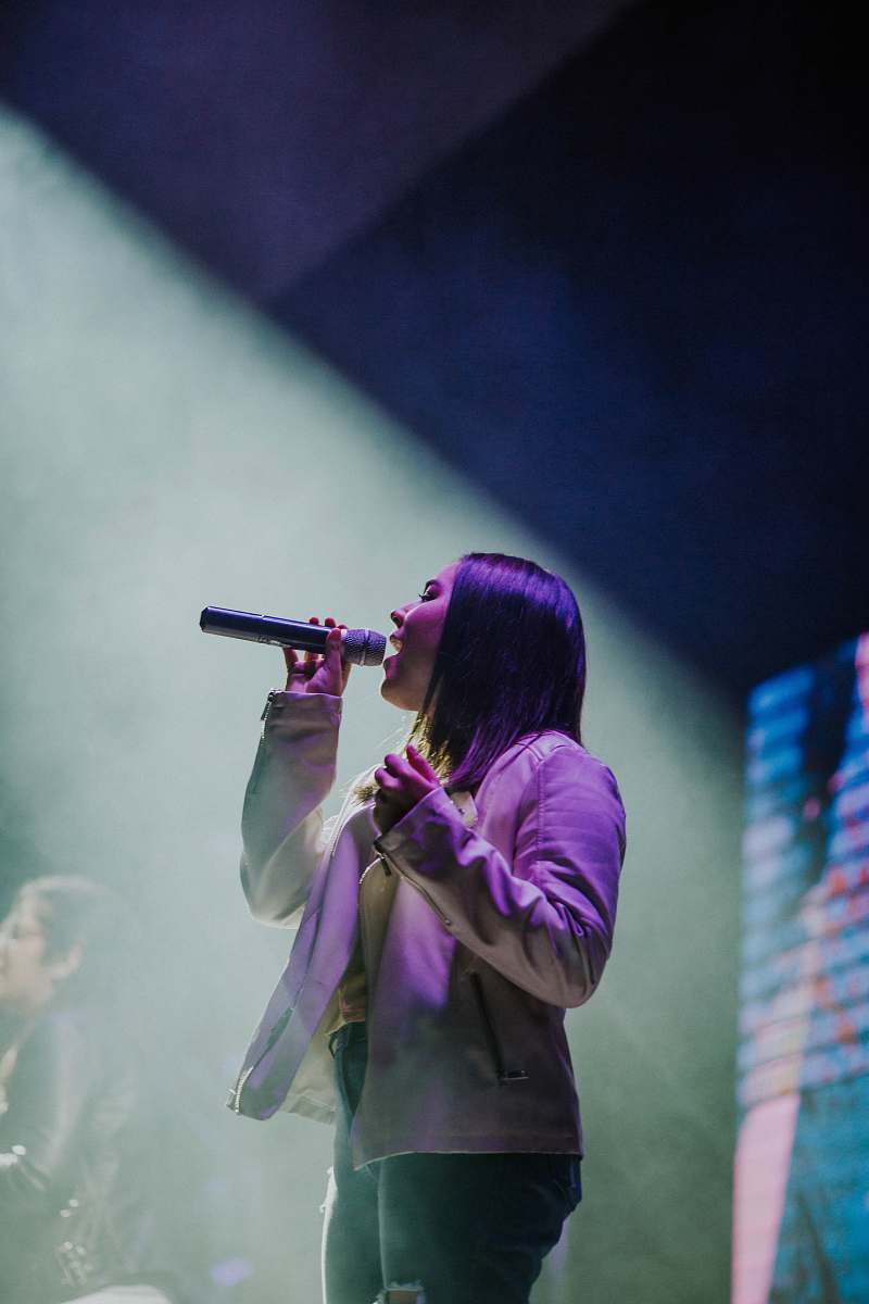 person girl holding microphone close-up photography electrical device