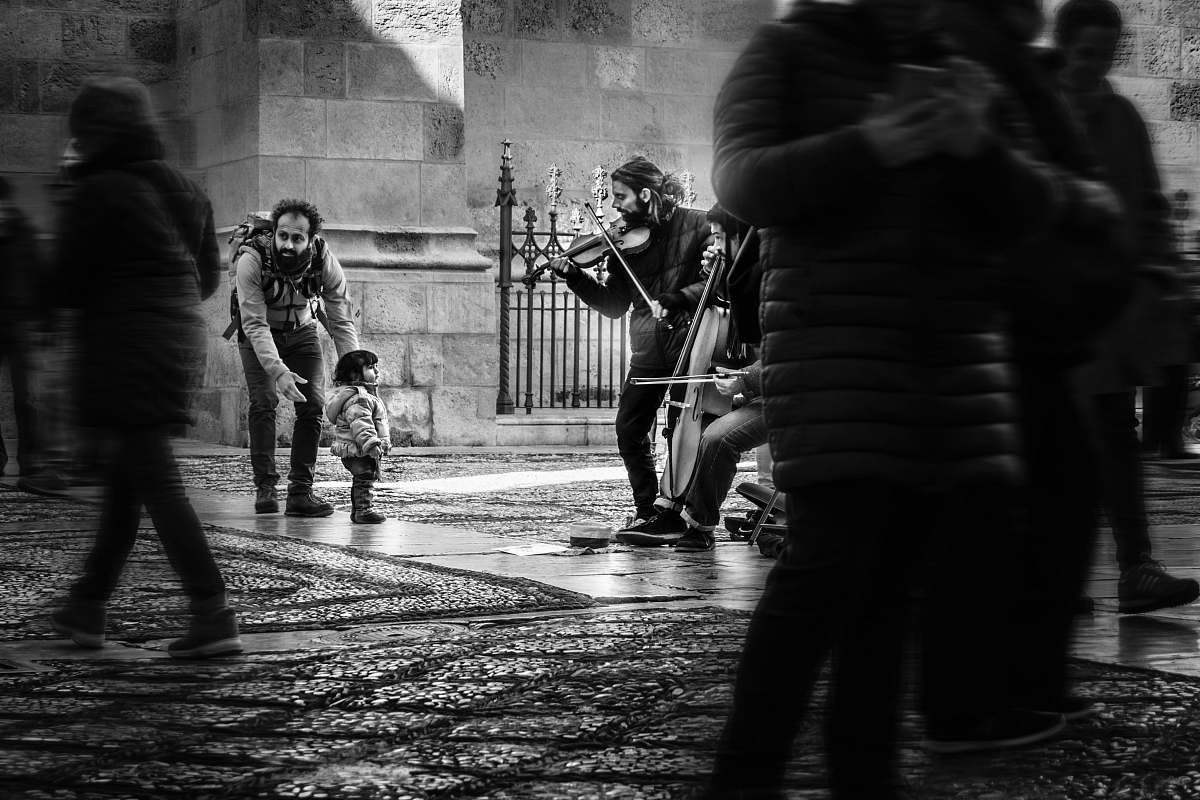 people grayscale girl watching men playing instruments black-and-white