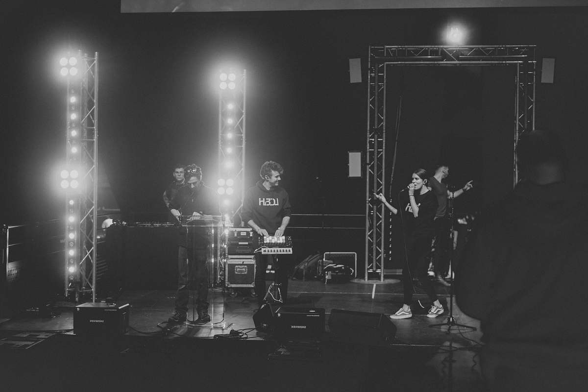 black-and-white grayscale photo of band performing on stage stage