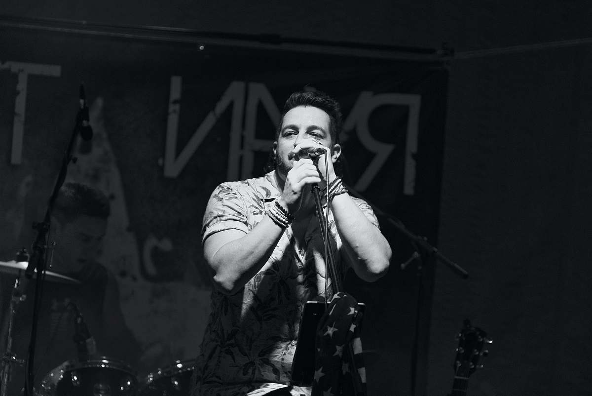 musician grayscale photography unknown person singing black-and-white