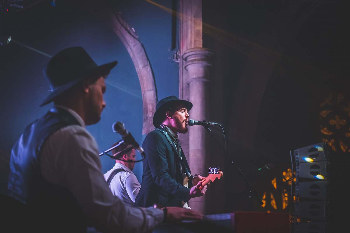 person group of band playing during night musician