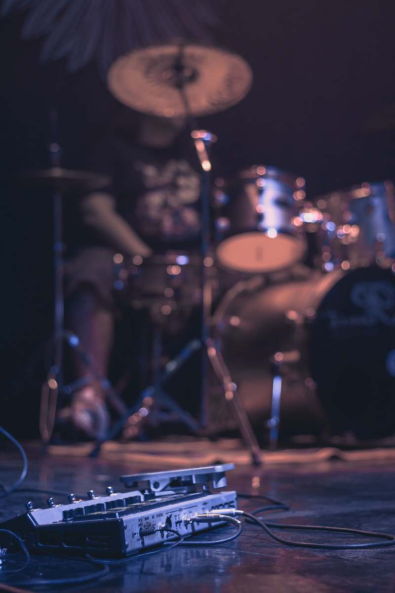 person low-angle photography of man playing drum set people