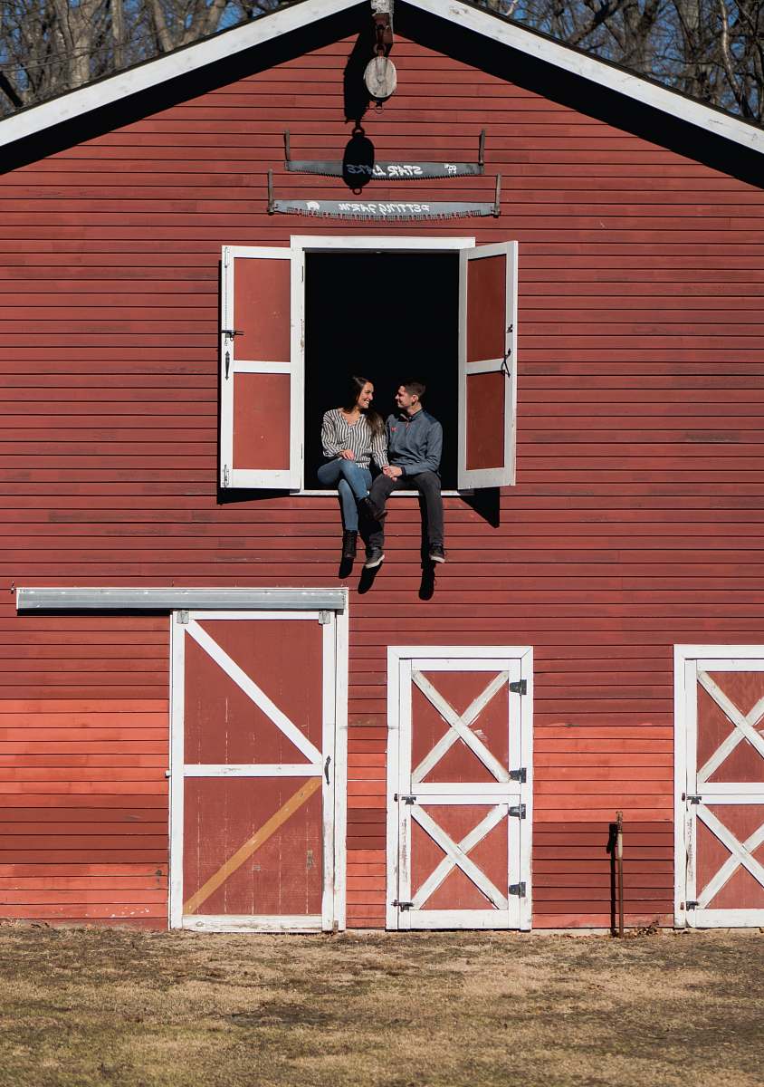 person man and woman sitting in stable window people