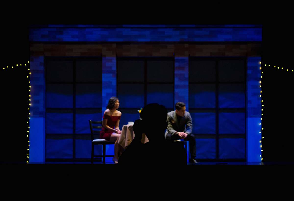 This striking image captures a man and woman sitting together on chairs, embodying the essence of theatrical artistry. Their expressions and body language tell a story that invites viewers to immerse themselves in the unfolding drama. Perfect for use in promotional materials for theater productions, workshops, or artistic blogs, this scene reflects the emotional depth and collaborative spirit of performance art.