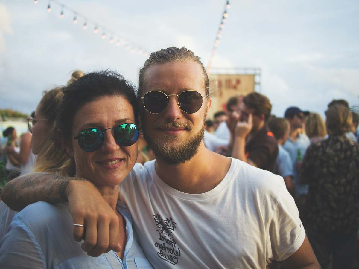 person man and woman smiling on focus photography sunglasses