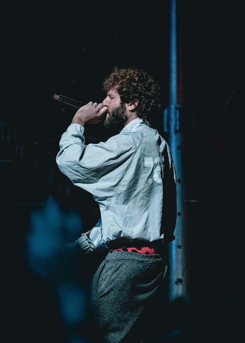 person man holding cordless microphone on stage people