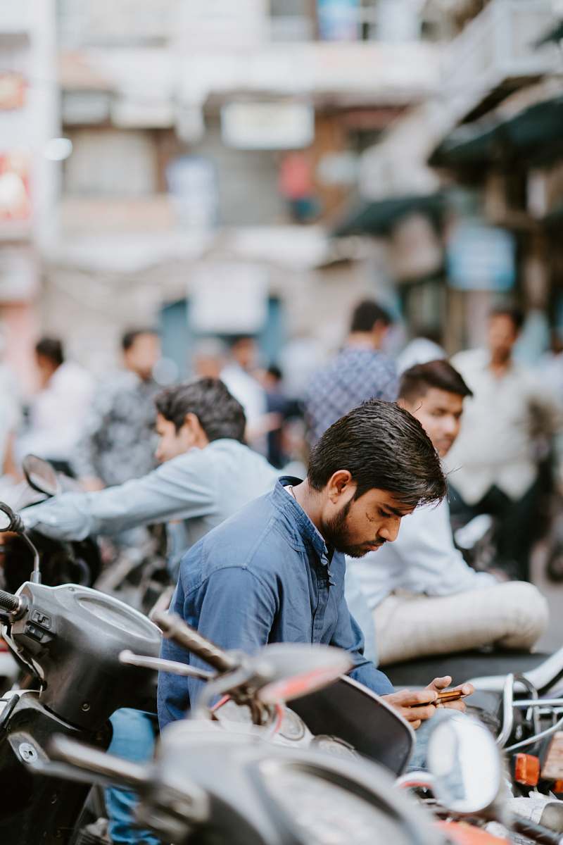 person man holding phone during day time people