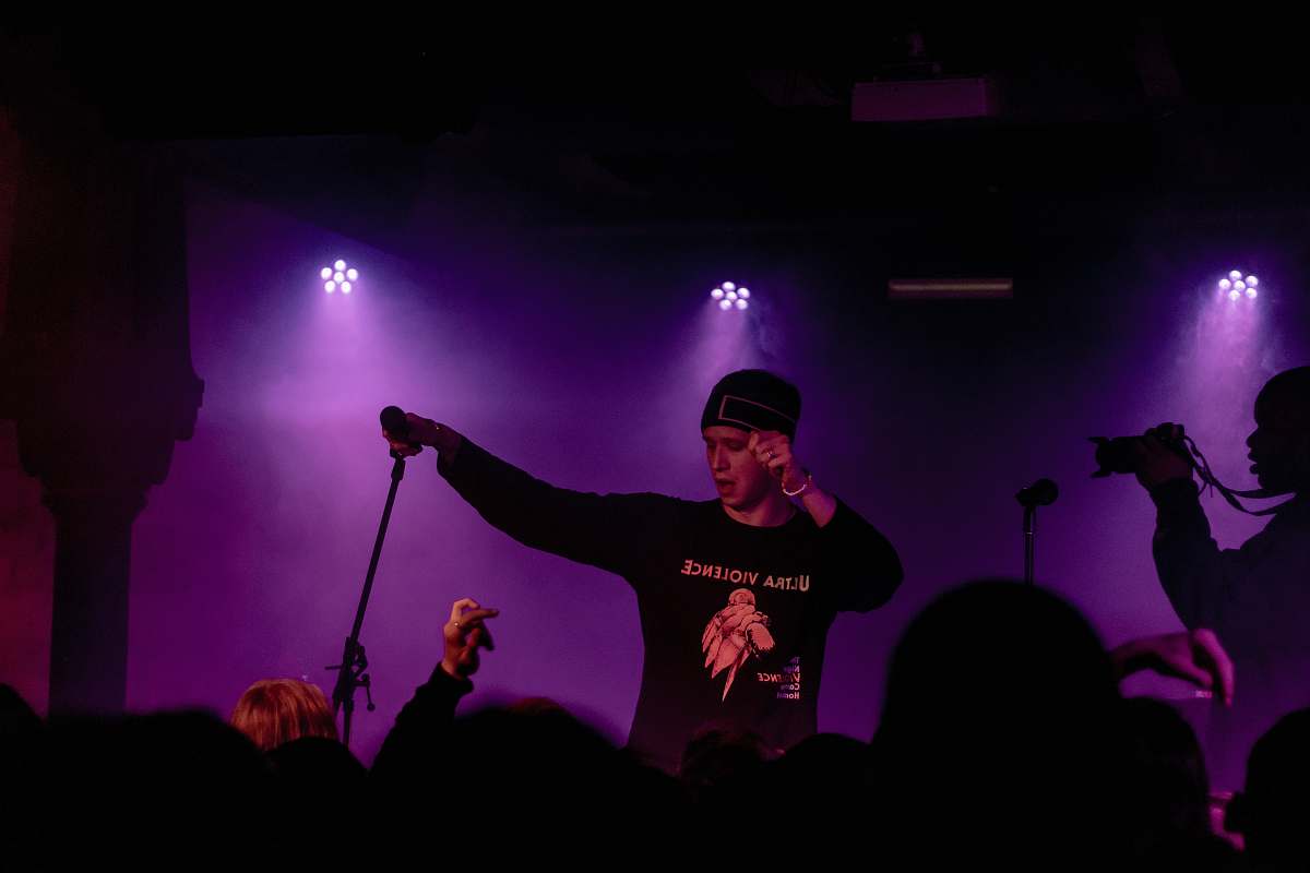 person man performing on stage lighting