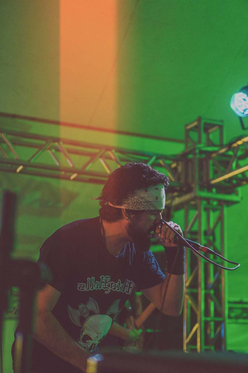 person man performing on stage while holding microphone musician