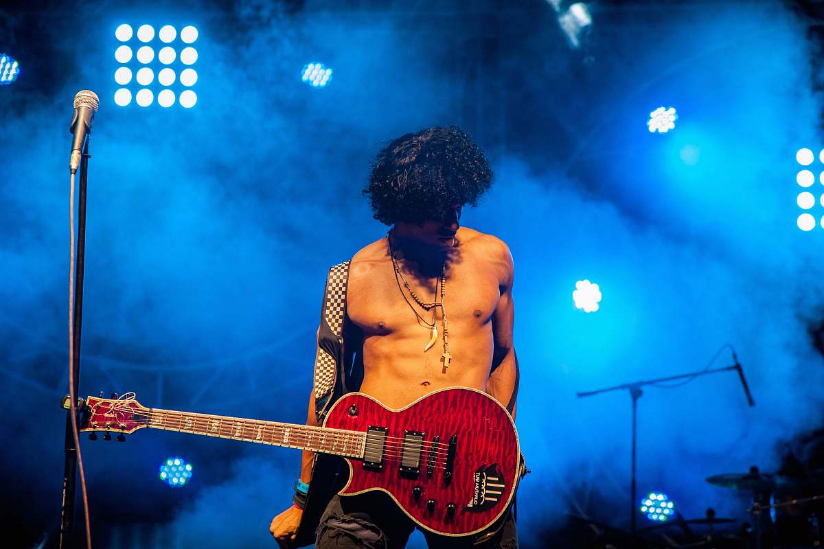 person man play electric guitar people