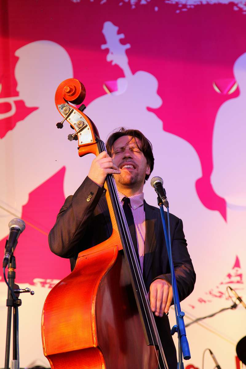 musician man playing cello in front of microphone microphone