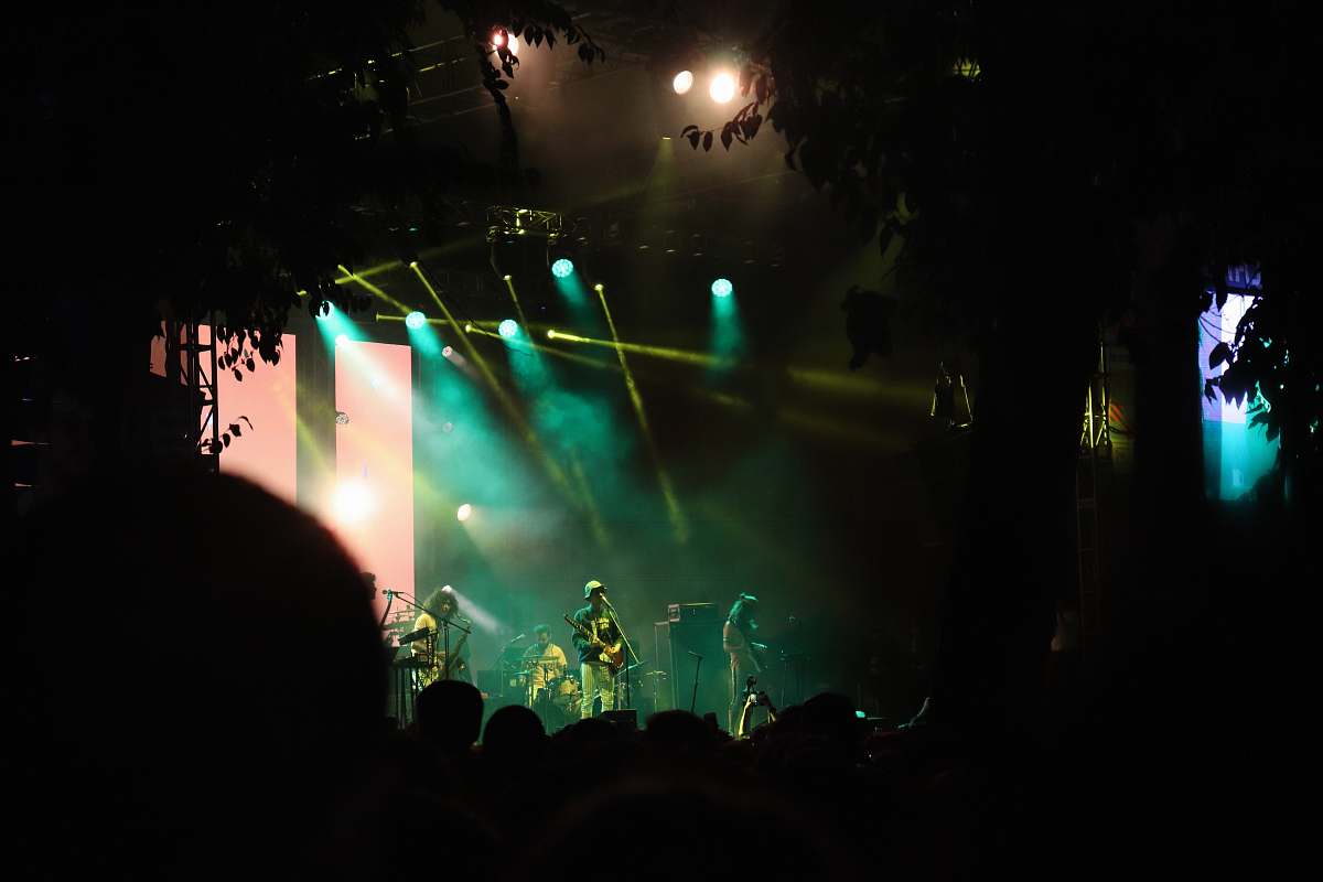 person man playing guitar in concert crowd