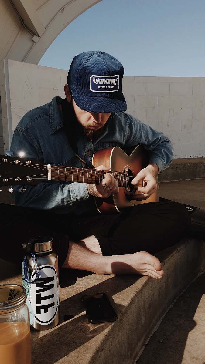 person man playing guitar guitar