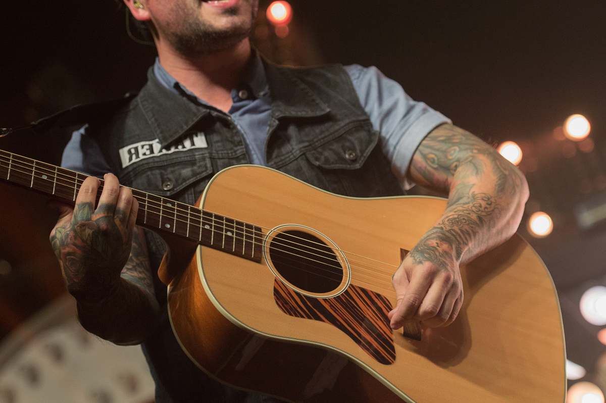 person man playing guitar while singing people