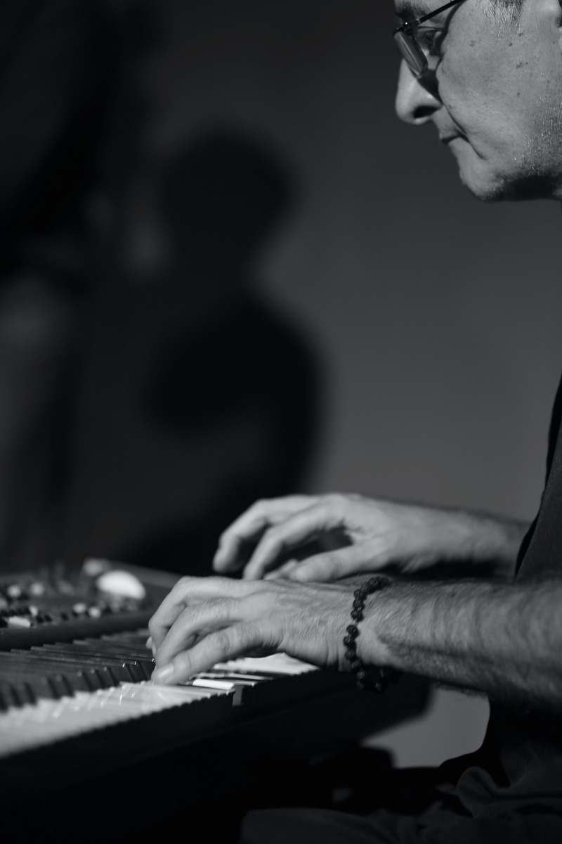 person man playing piano black-and-white