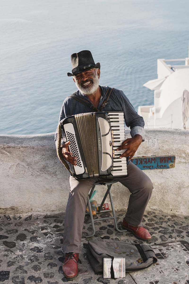 person man playing white accordion musician