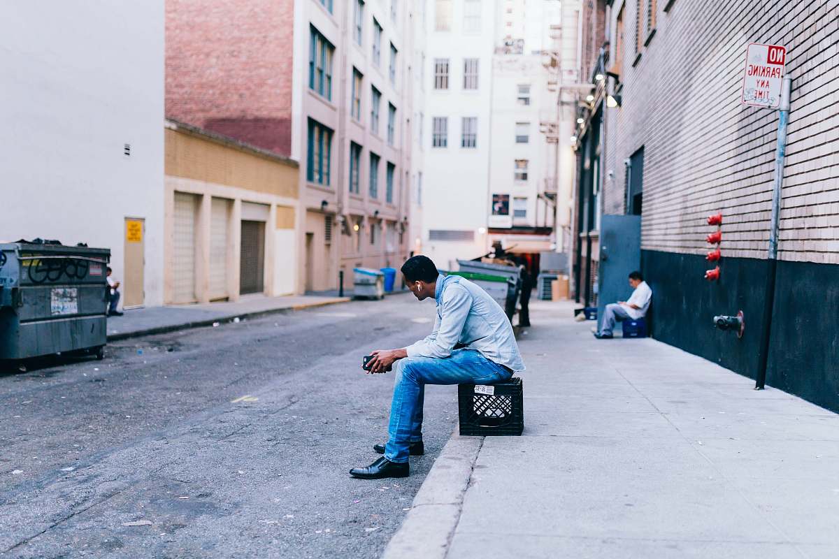 person man sitting on crate people