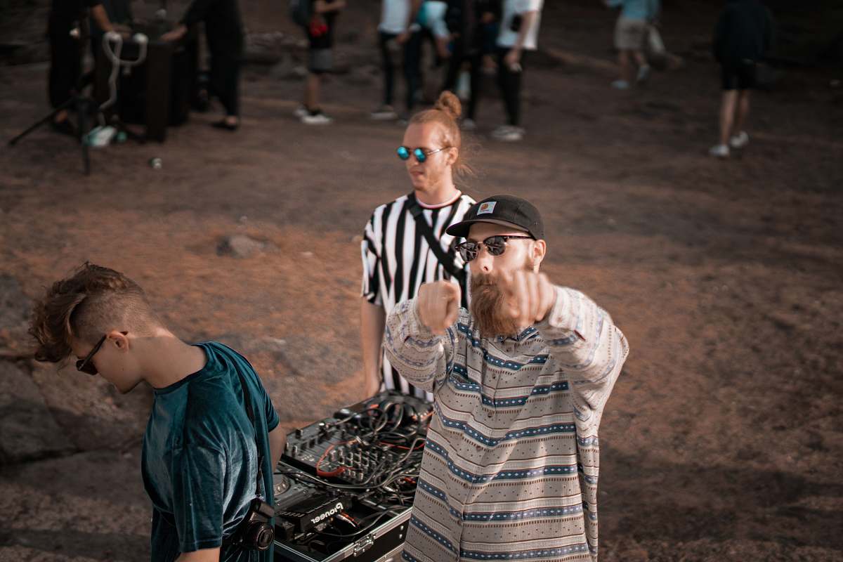 person man standing near black audio mixer people