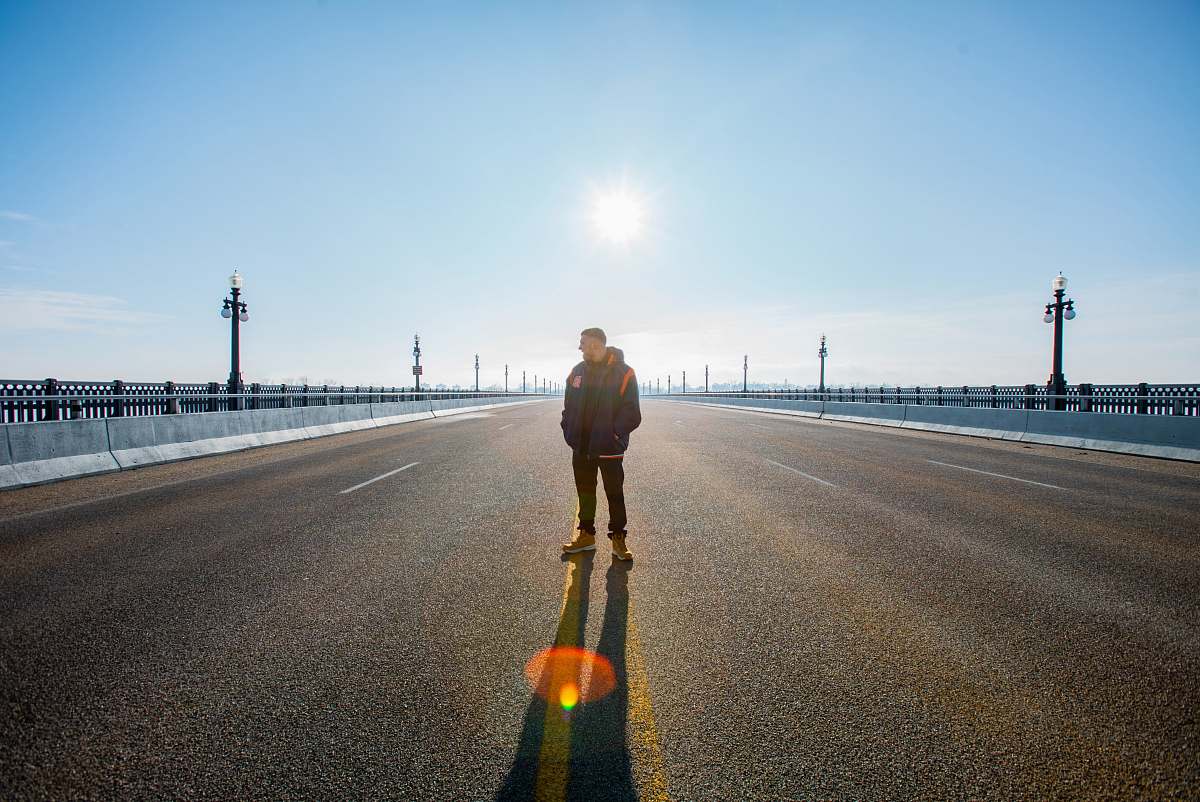 person man standing on road pedestrian