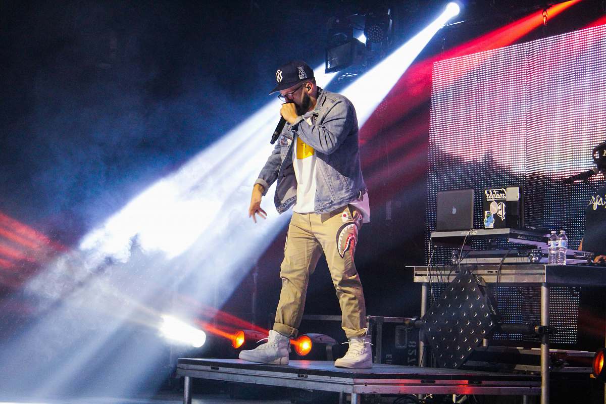 person man standing on stage during nighttime people
