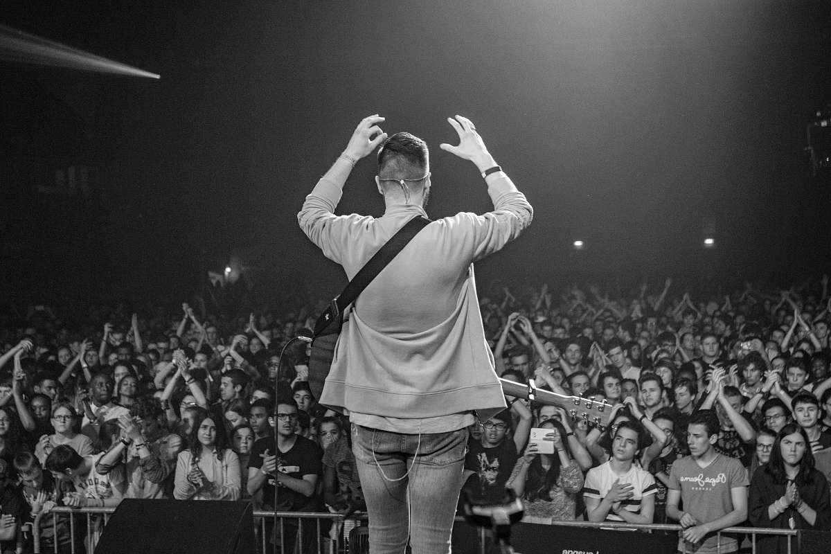 people man standing on stage black-and-white