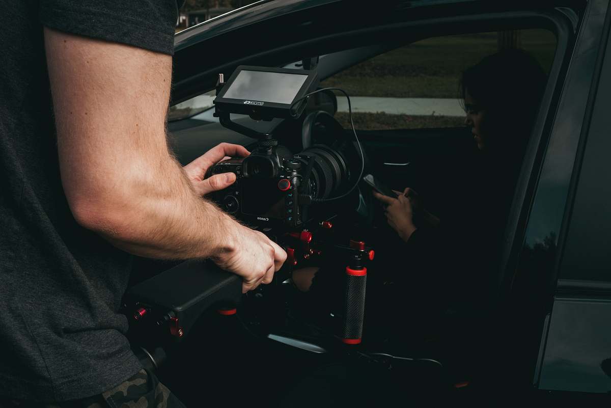 person man taking video of woman inside vehicle camera