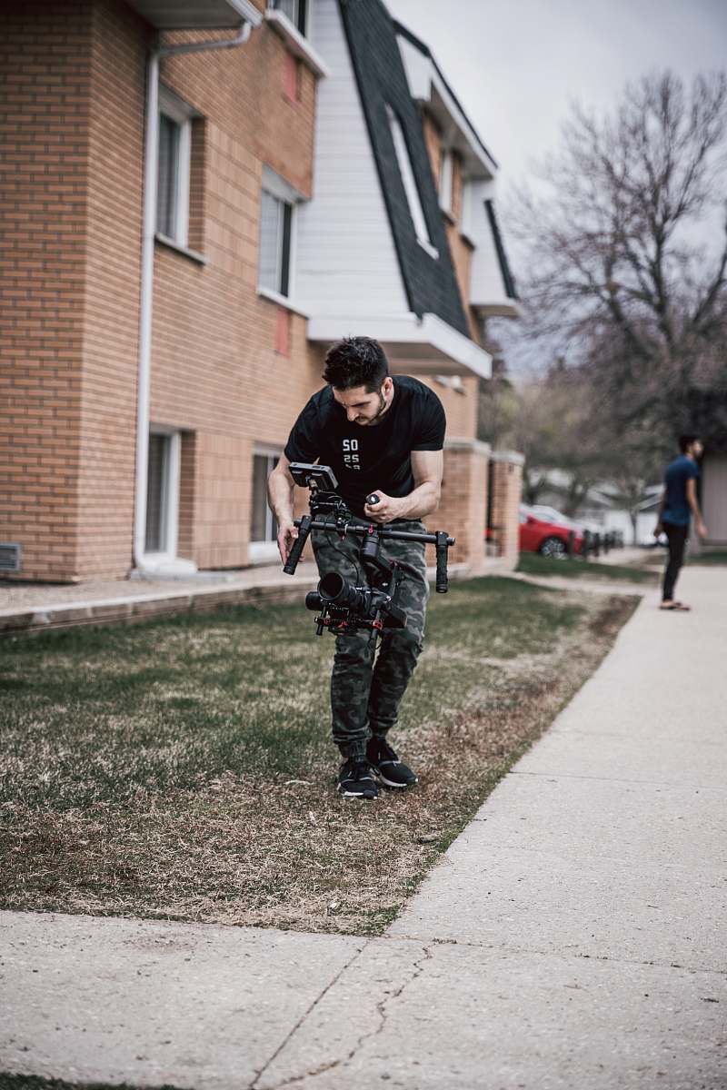 person man using drone standing in green field clothing
