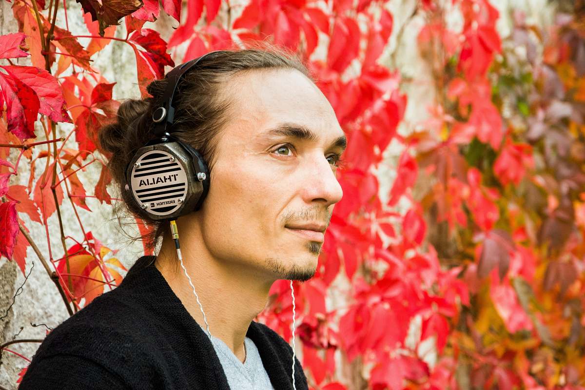 person man wearing black and gray headphones headphones