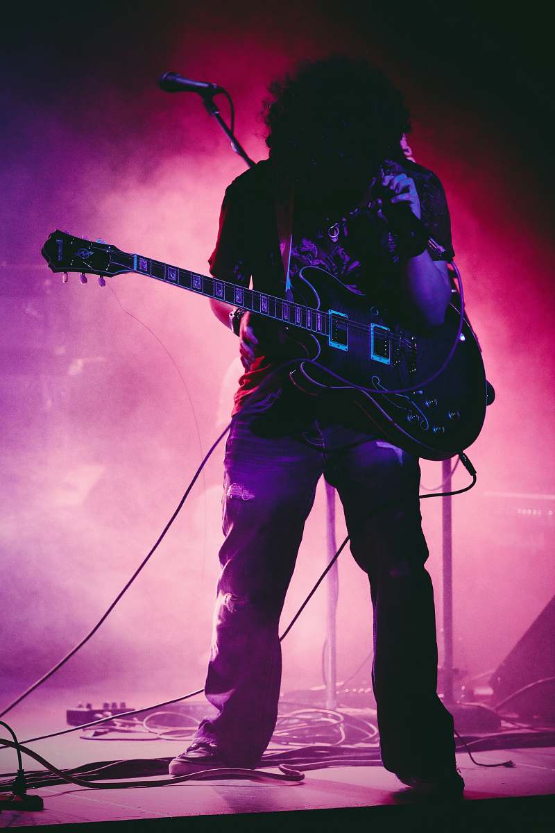 person man with guitar on concert stage people