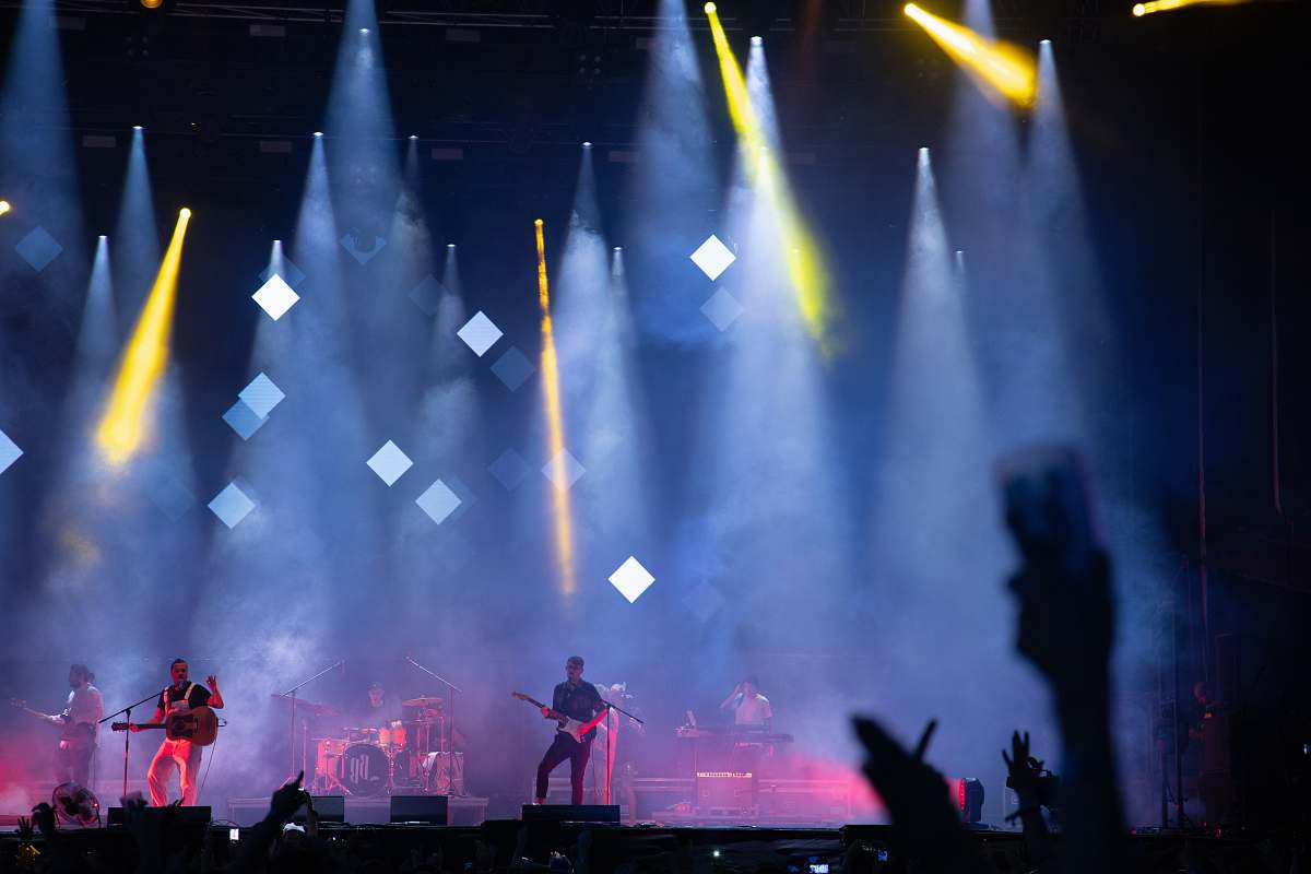 lighting men playing guitar on stage stage