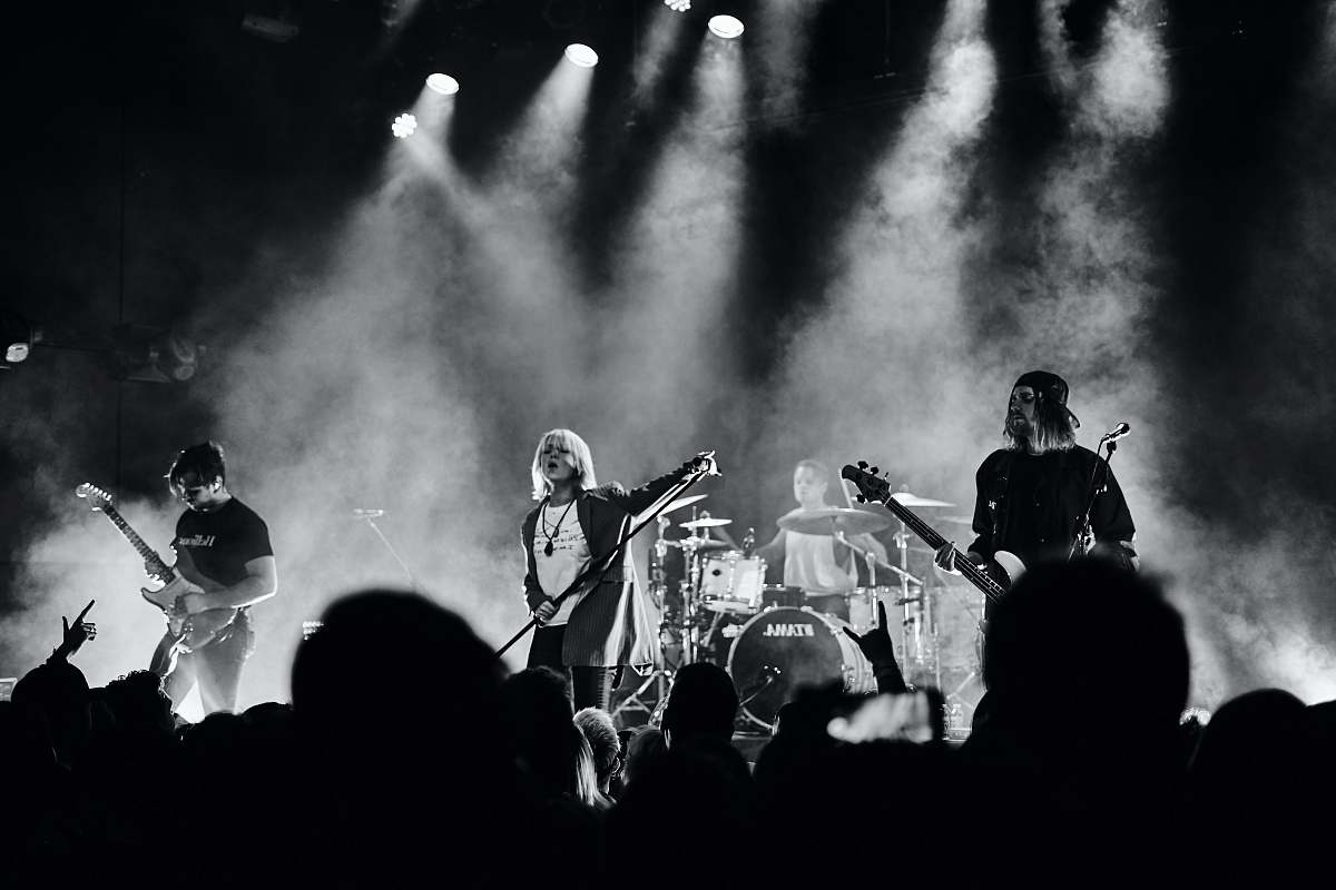black-and-white men playing musical instruments on stage stage