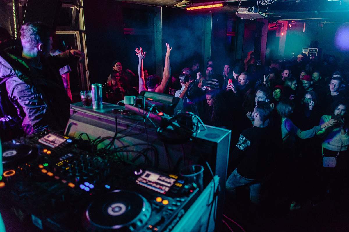 person people inside building at night dj
